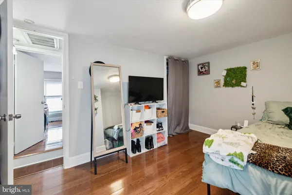 a bedroom with furniture and a flat screen tv