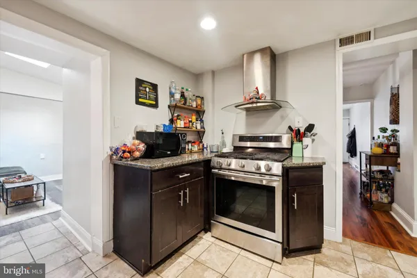 a kitchen with stainless steel appliances granite countertop a stove and a refrigerator