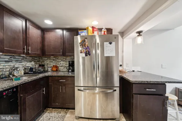 a kitchen with a refrigerator a sink and cabinets