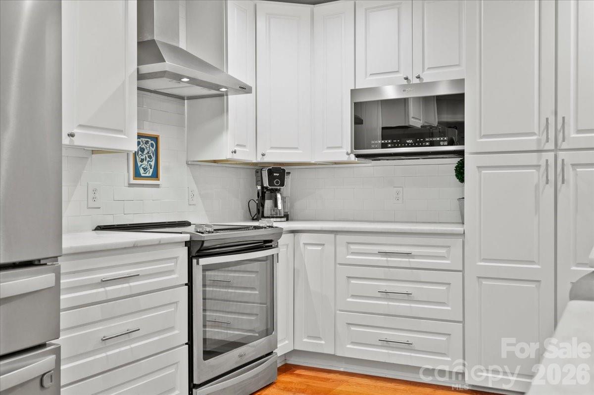 209 Fairway Road Cheraw, SC 29520 - Photo 9 of 48 a kitchen with white cabinets and appliances