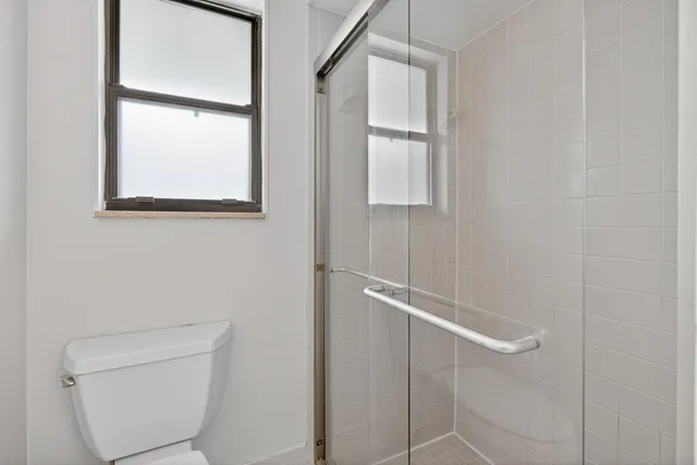 a bedroom with two beds and a window