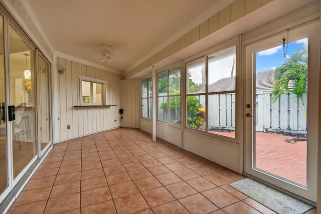 a view of a entryway door with living room and chandelier