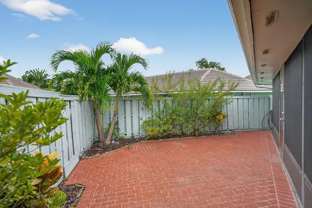 a view of a house with backyard and a trees