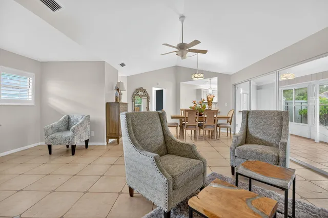 a living room with furniture dining table and a chandelier