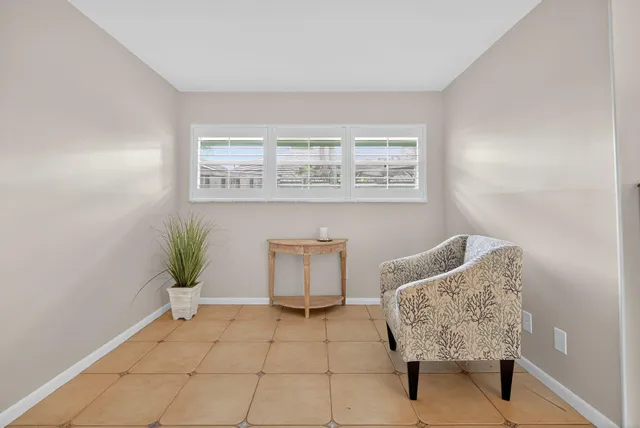 a view of room with furniture and potted plants