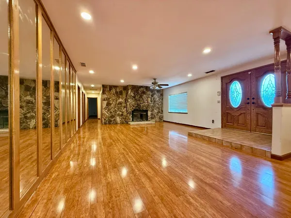 a view of a hall with wooden floor