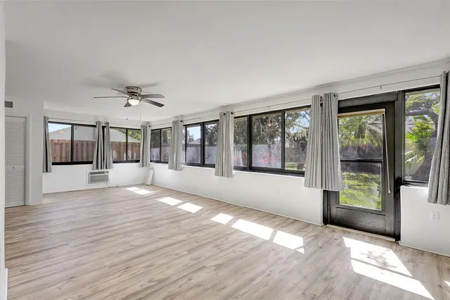 a large bedroom with a bed and a chandelier