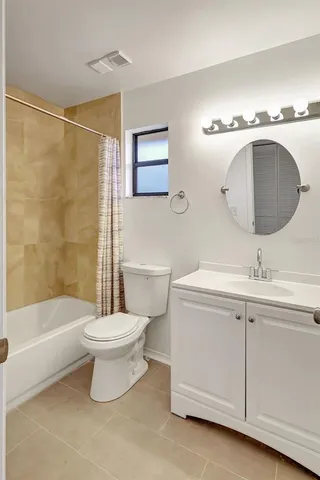 a kitchen with granite countertop a refrigerator a stove top oven a sink and dishwasher