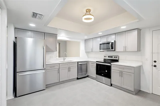 a large kitchen with a refrigerator a sink dishwasher a stove and a refrigerator