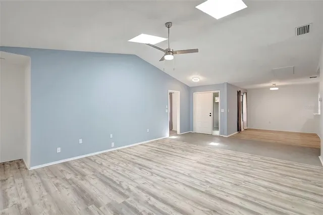 a view of an empty room with a ceiling fan