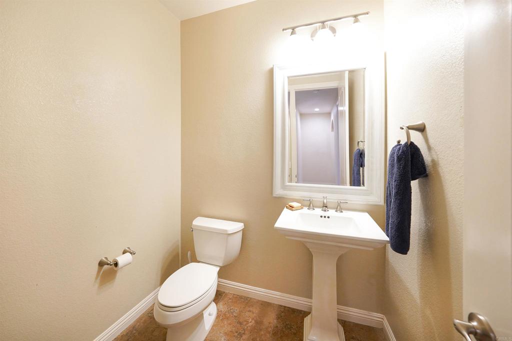 22963 Stokes Road Ramona, CA 92065 - Photo 44 of 57 a bathroom with a toilet sink and mirror