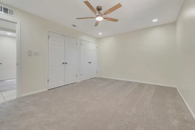 an empty room with a ceiling fan and a ceiling fan