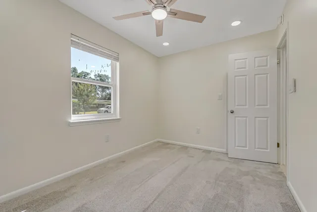 a bathroom with a sink mirror vanity and toilet