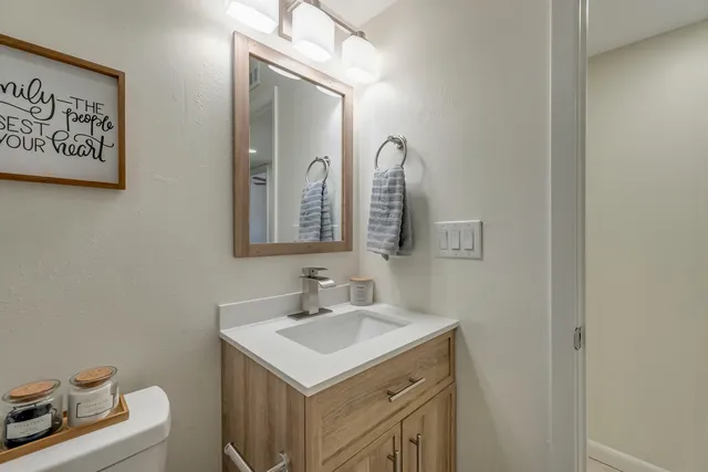 an empty room with windows and ceiling fan
