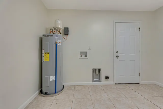 an empty room with stairs and windows