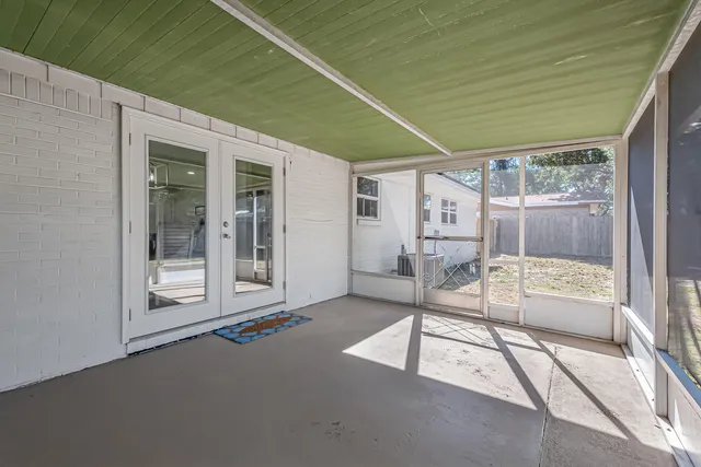 a view of backyard with barbeque grill and wooden fence