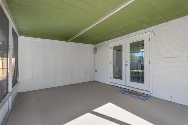 a view of a house with backyard and a tree