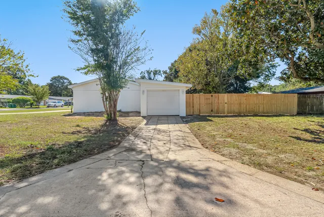 a view of house with outdoor space and swimming pool