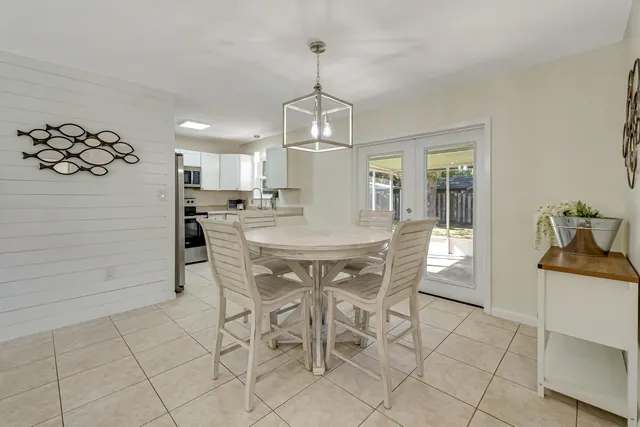 a view of a dining room with furniture and chandelier