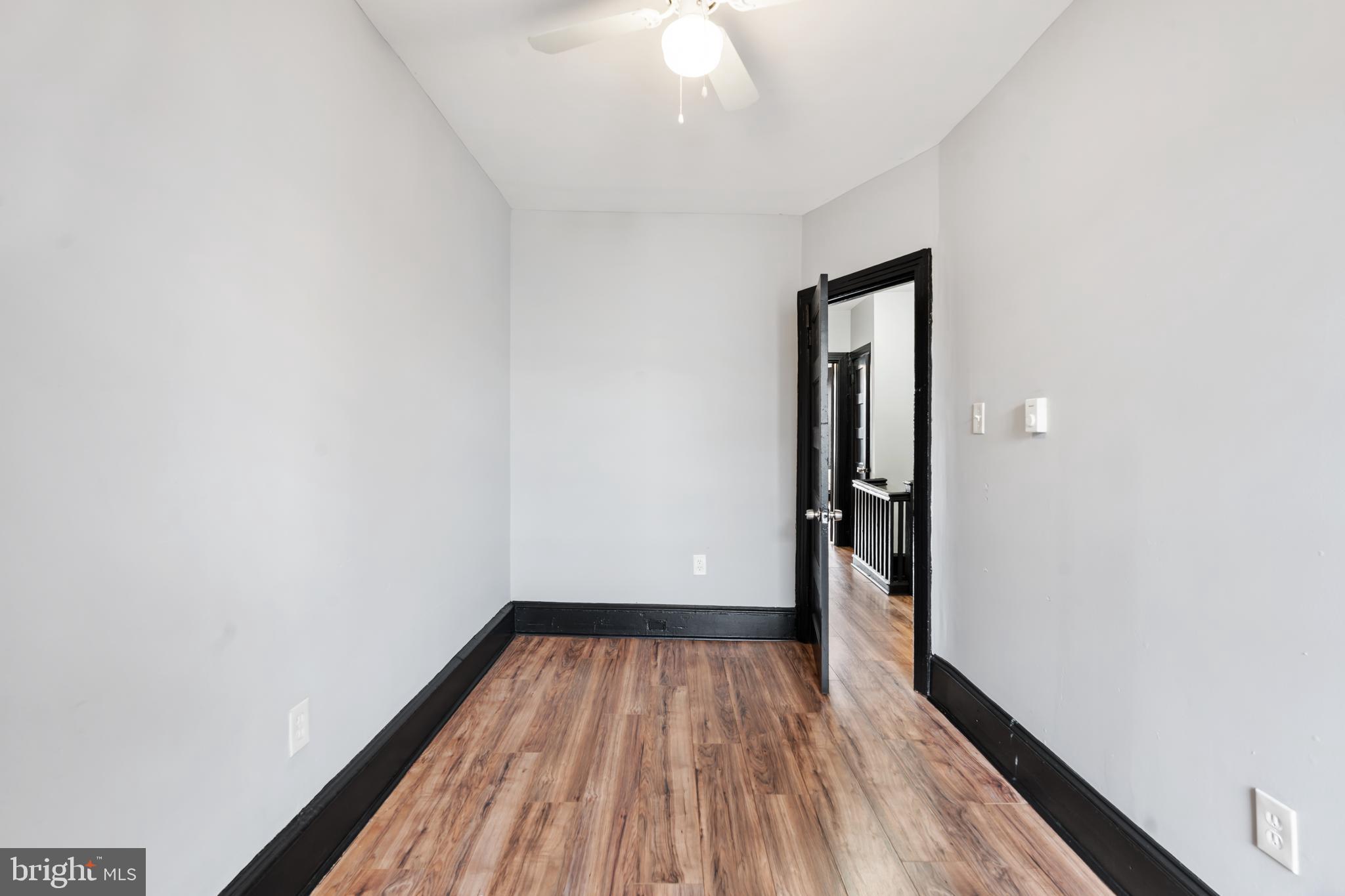 3239 North 26th Street Philadelphia, PA 19129 - Photo 19 of 28 a view of a room with wooden floor and a ceiling fan