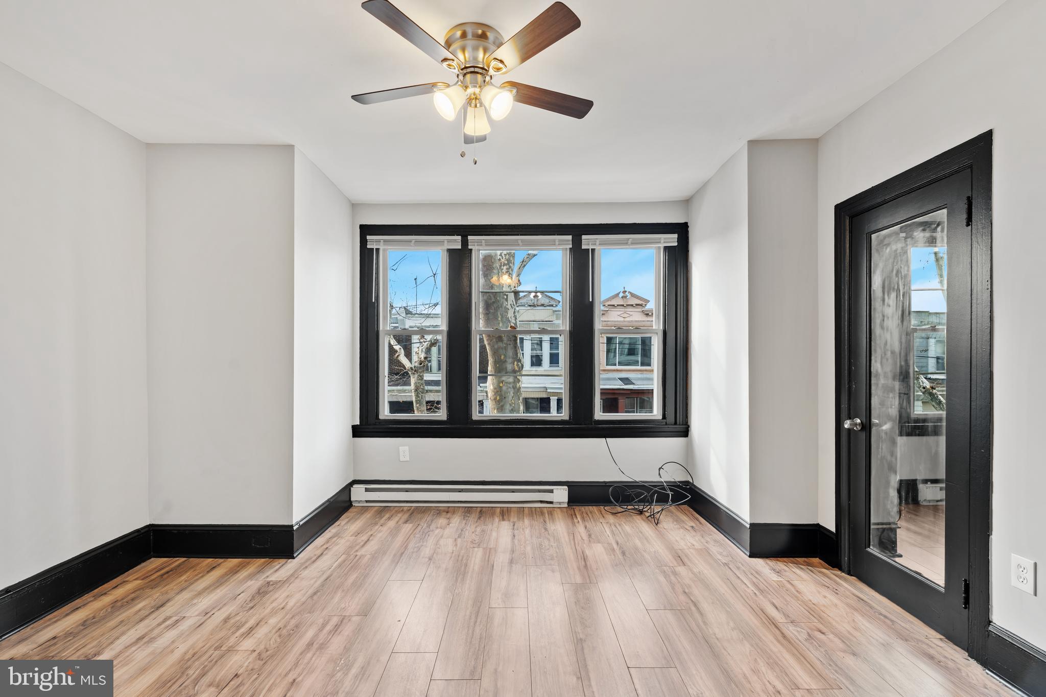 3239 North 26th Street Philadelphia, PA 19129 - Photo 23 of 28 wooden floor in an empty room with a window