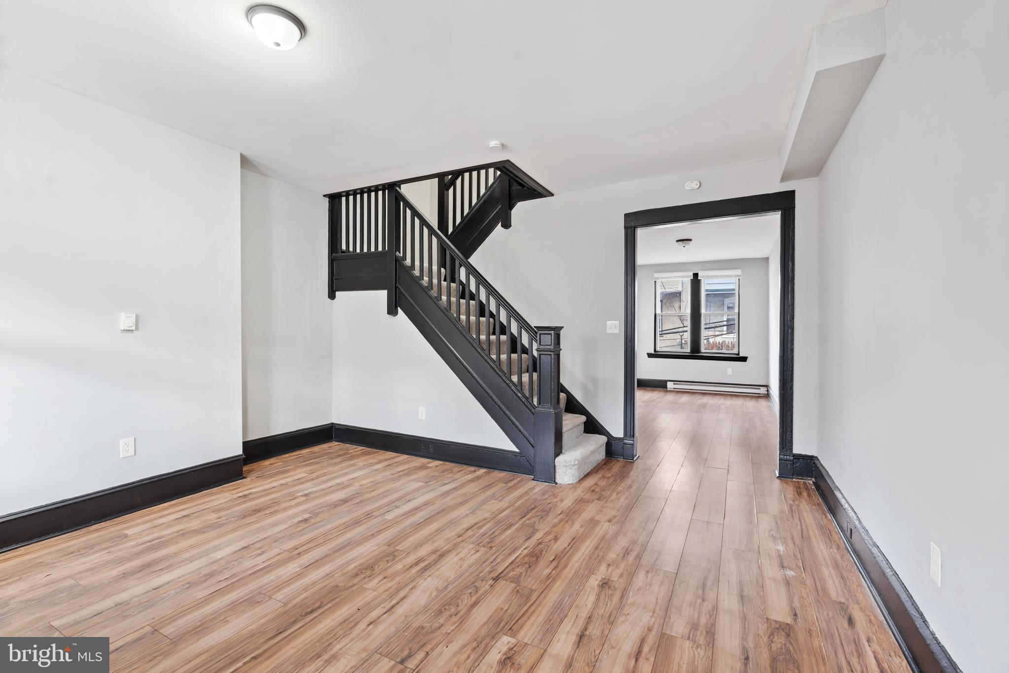 3239 North 26th Street Philadelphia, PA 19129 - Photo 3 of 28 a view of a hallway with wooden floor and staircase