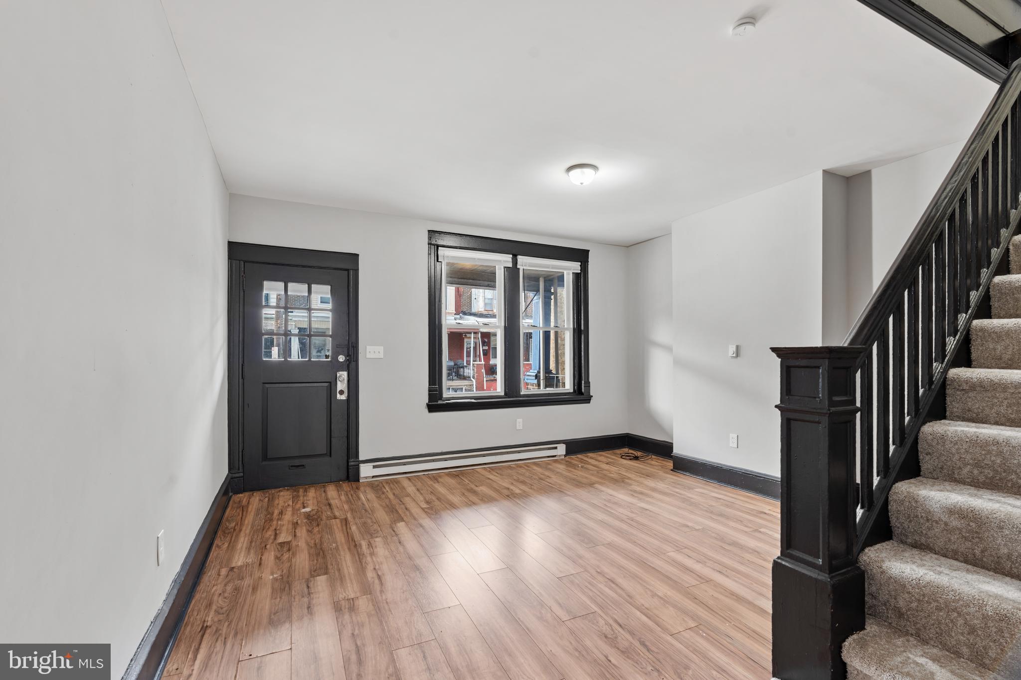 3239 North 26th Street Philadelphia, PA 19129 - Photo 5 of 28 a view of an empty room with glass door and wooden floor