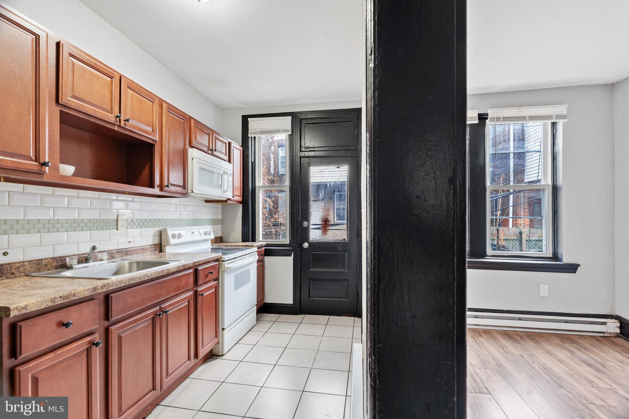 3239 North 26th Street Philadelphia, PA 19129 - Photo 9 of 28 a kitchen with a sink stove and microwave