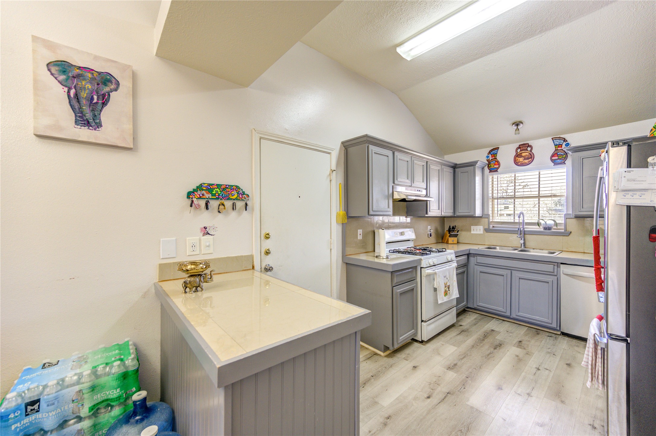 23618 Tree House Lane Spring, TX 77373 - Photo 12 of 46 a kitchen with a sink stove and refrigerator