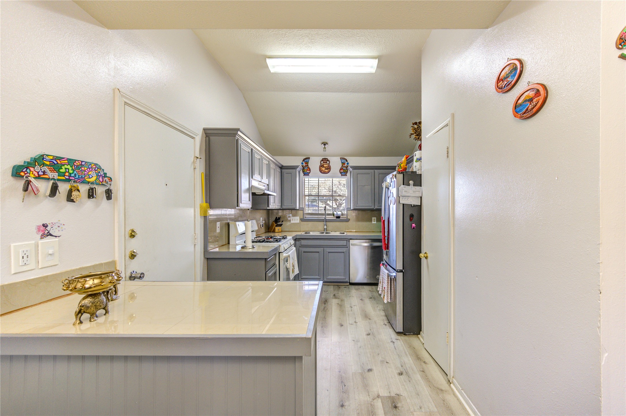 23618 Tree House Lane Spring, TX 77373 - Photo 13 of 46 a view of a kitchen with kitchen island a sink stainless steel appliances and cabinets