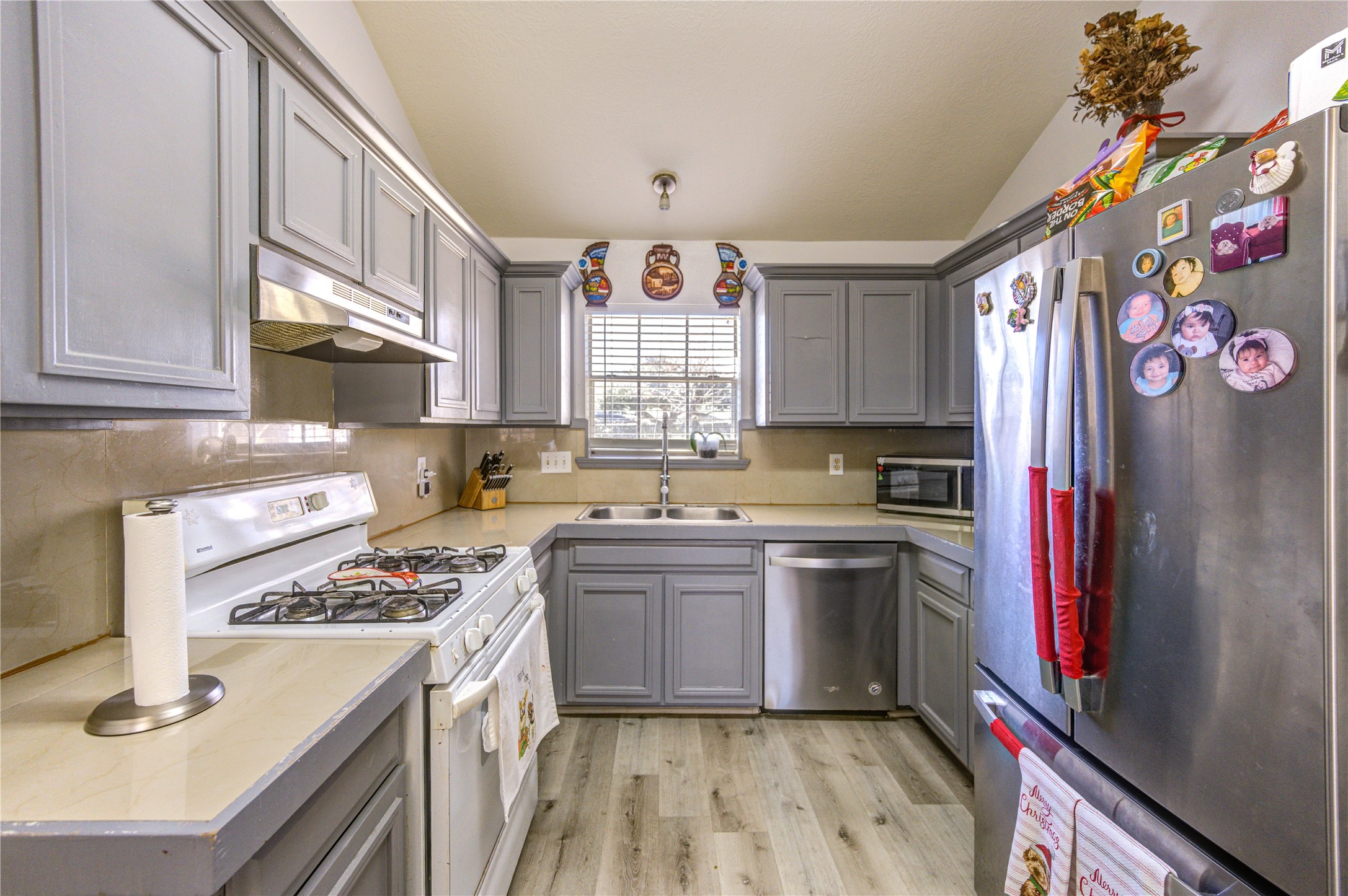 23618 Tree House Lane Spring, TX 77373 - Photo 14 of 46 a kitchen with a refrigerator stove and sink