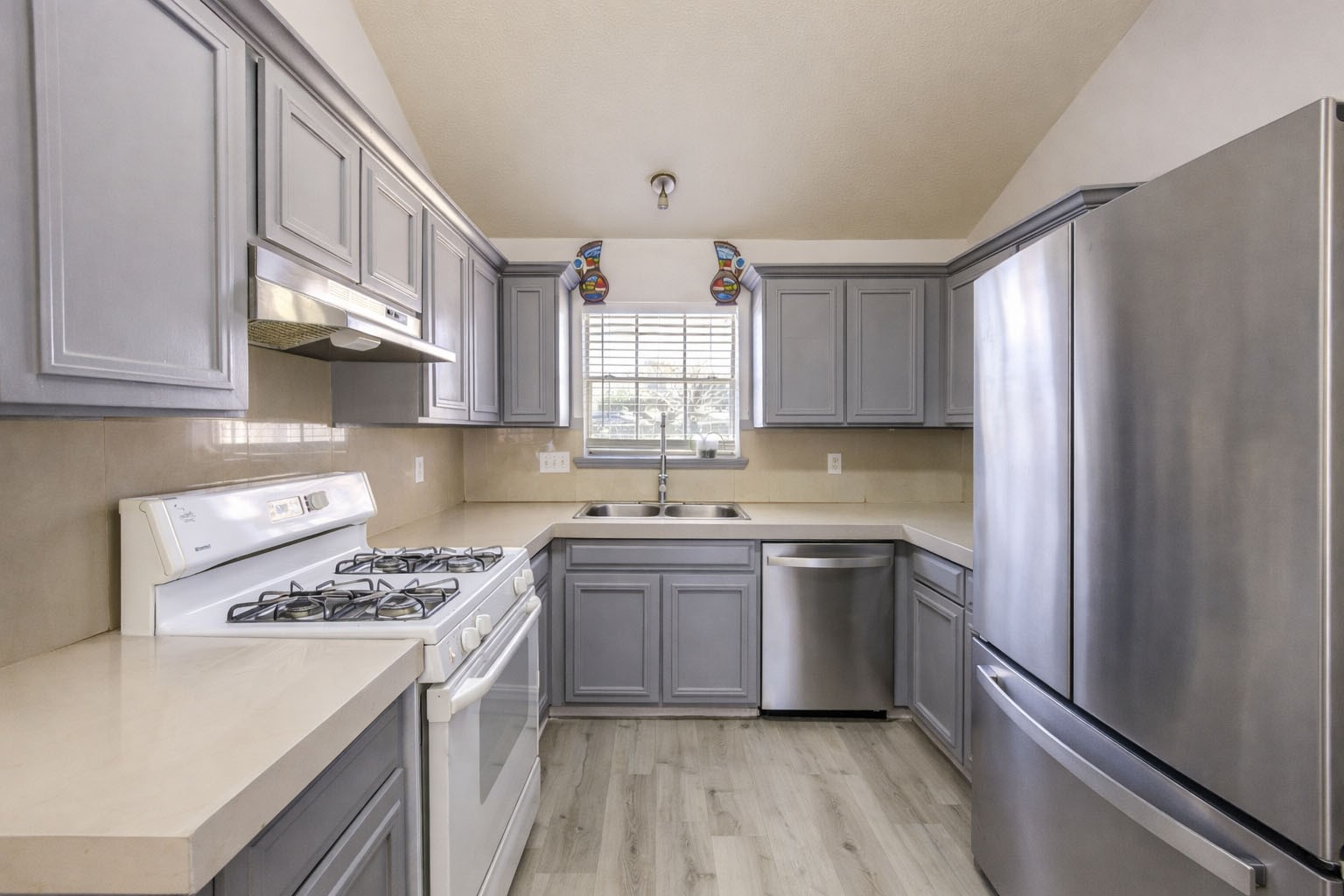 23618 Tree House Lane Spring, TX 77373 - Photo 15 of 46 a kitchen with a sink stove top oven and cabinets