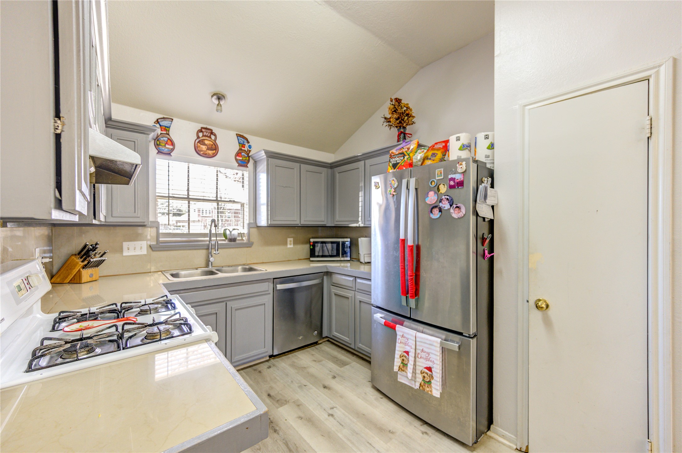 23618 Tree House Lane Spring, TX 77373 - Photo 16 of 46 a kitchen with stainless steel appliances granite countertop a sink and a refrigerator