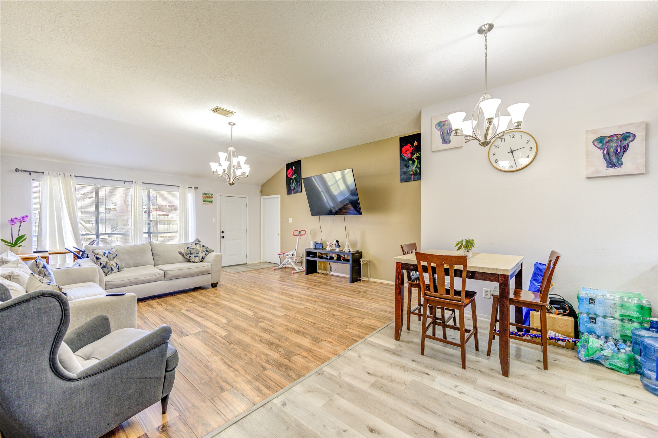 23618 Tree House Lane Spring, TX 77373 - Photo 20 of 46 a living room with furniture a dining table and a chandelier