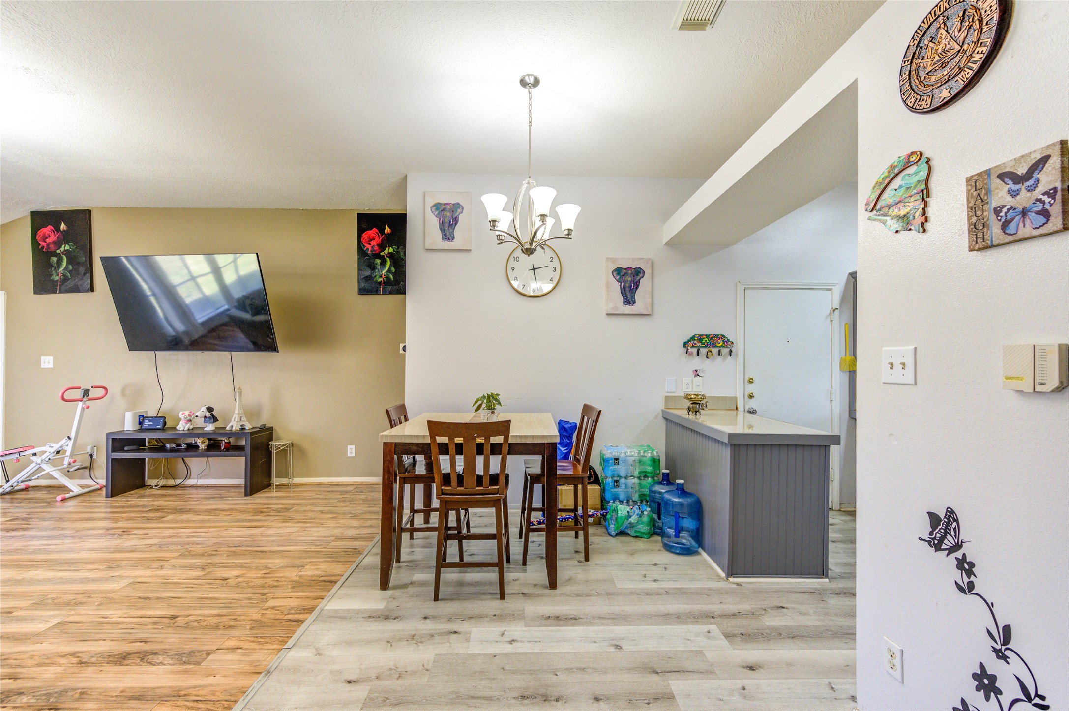 23618 Tree House Lane Spring, TX 77373 - Photo 21 of 46 a dining room with wooden floor a chandelier a wooden table and chairs