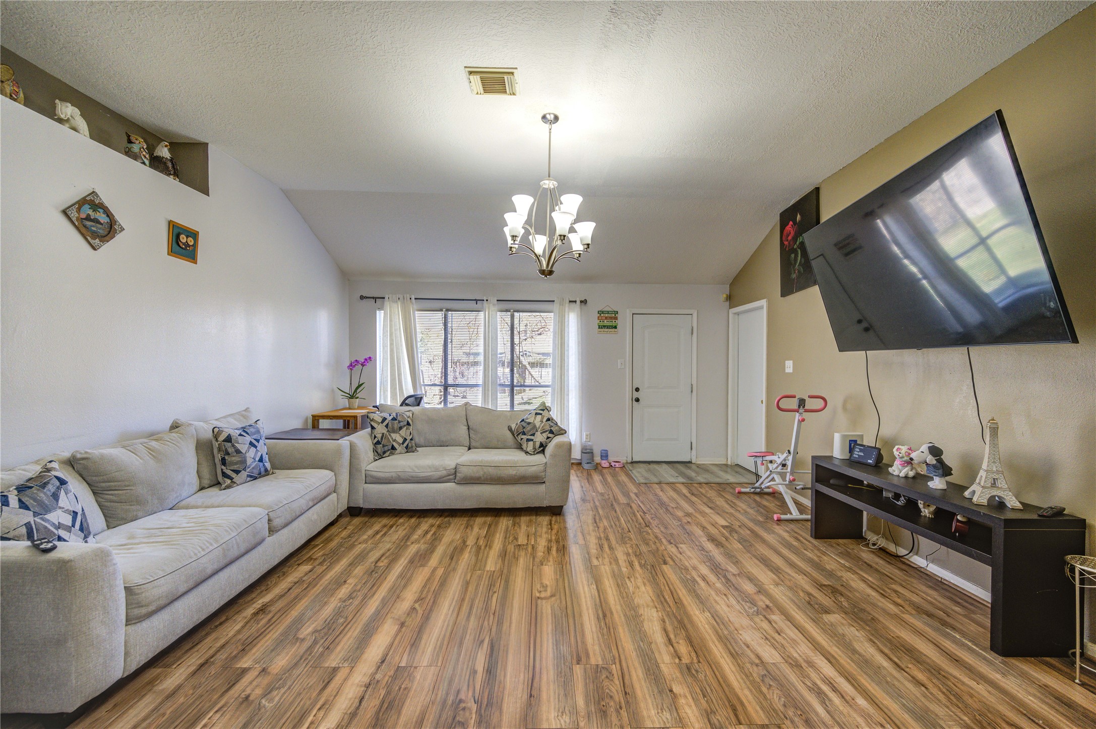 23618 Tree House Lane Spring, TX 77373 - Photo 23 of 46 a living room with furniture and a chandelier