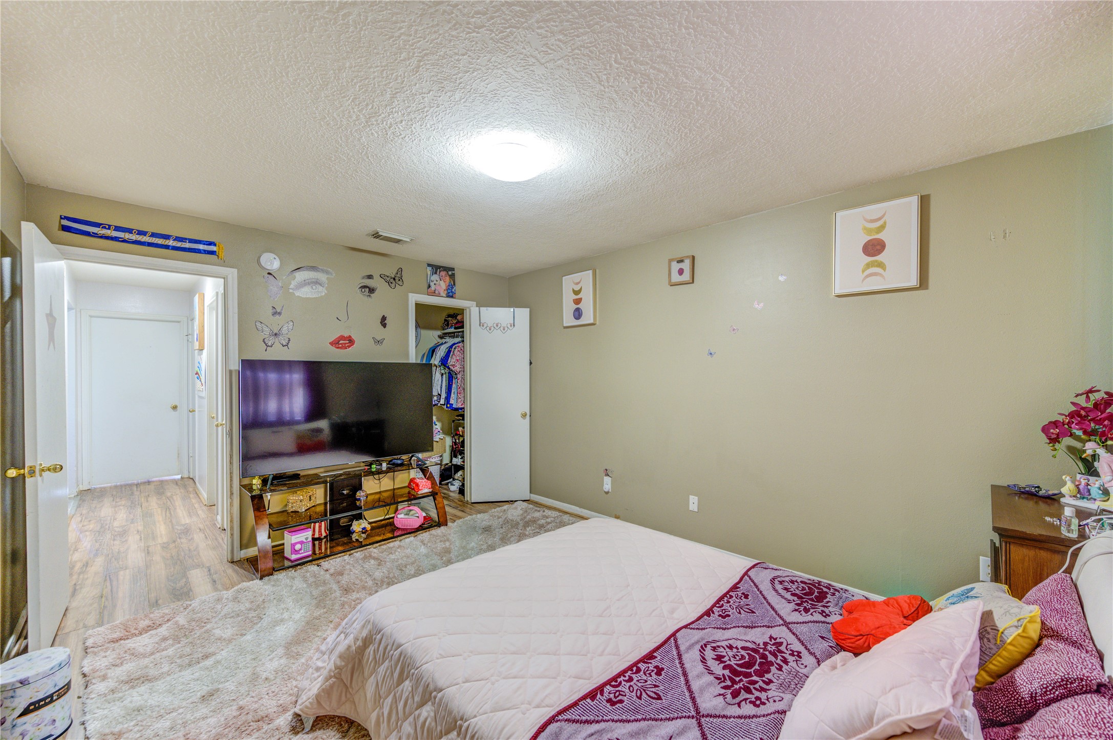 23618 Tree House Lane Spring, TX 77373 - Photo 10 of 46 a bedroom with a bed and a flat screen tv