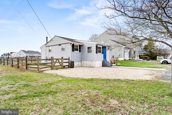 a white house with a yard and sitting area