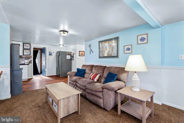 a living room with furniture and a lamp