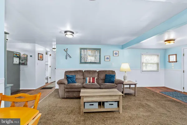 a living room with furniture and a lamp