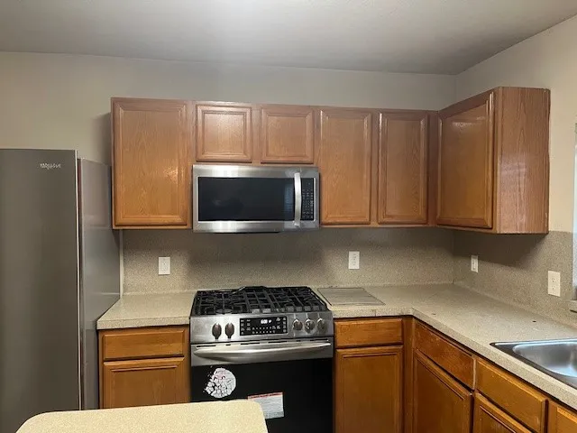 a kitchen with a stove and a microwave