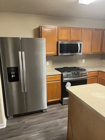 a kitchen with a refrigerator and a stove