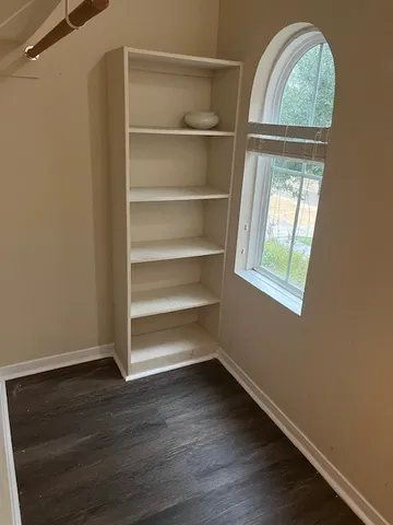a view of room with window and wooden floor