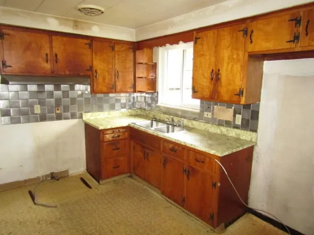 a kitchen with a sink stove and cabinets