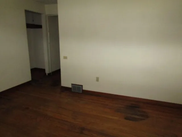 an empty room with wooden floor