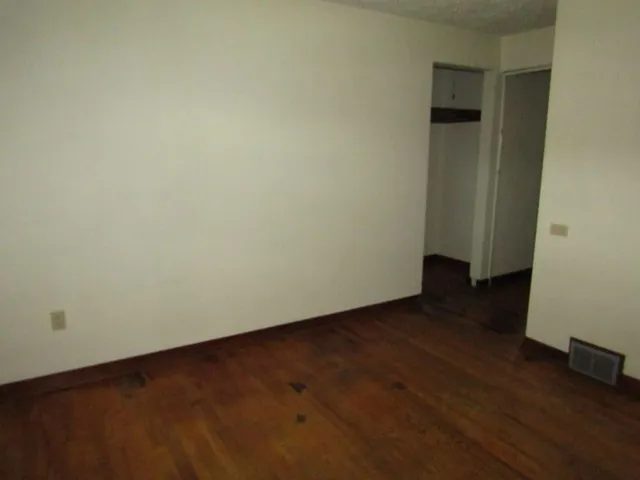 an empty room with wooden floor
