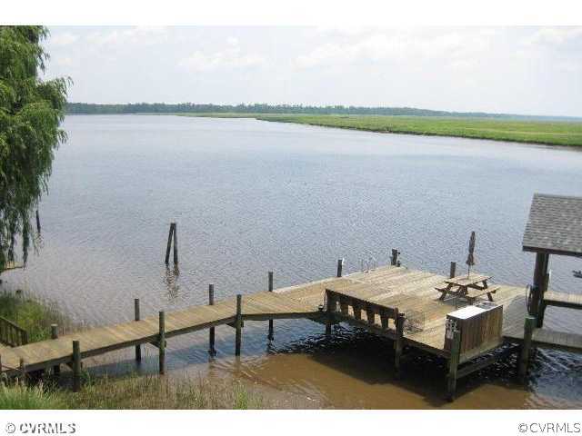 4983 Wakema Road West Point, VA 23181 - Photo 11 of 12 a view of a terrace with furniture and a lake view