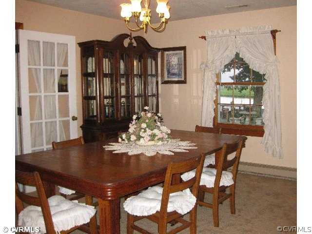 4983 Wakema Road West Point, VA 23181 - Photo 3 of 12 a view of a dining room with furniture and window