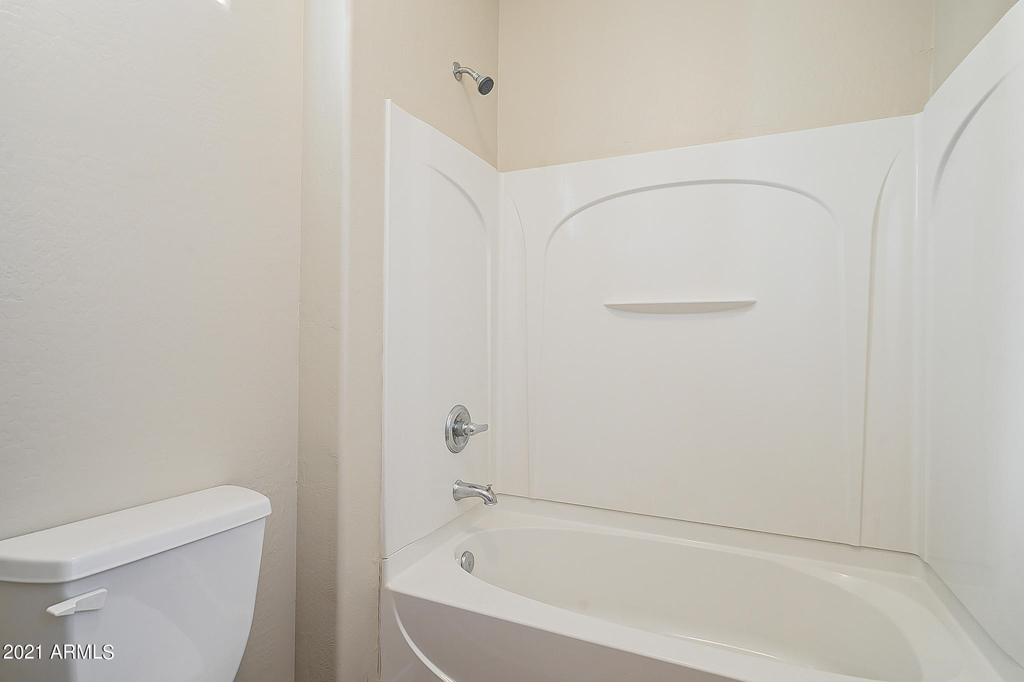 15346 West Boca Raton Road Surprise, AZ 85379 - Photo 35 of 45 a white bath tub sitting next to a white toilet and vanity