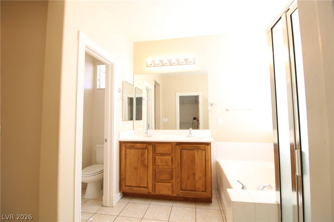 754 Rise Canyon Drive Henderson, NV 89052 - Photo 25 of 34 Dual vanities and a deep soaking tub create a restful bathroom retreat.
